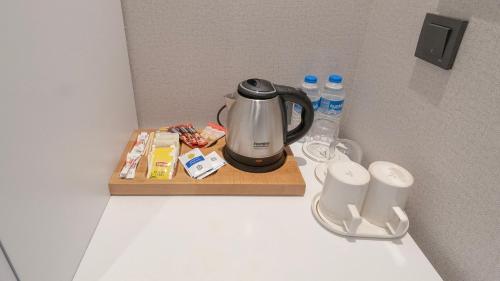 a coffee maker sitting on a counter next to water bottles at Loop Hotel Bosphorus İstanbul in Istanbul