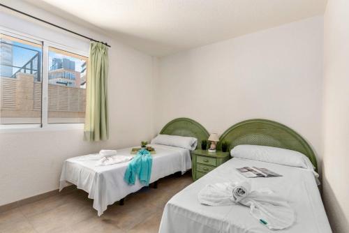 A bed or beds in a room at Apartamento Arenal 1 - PlusHolidays