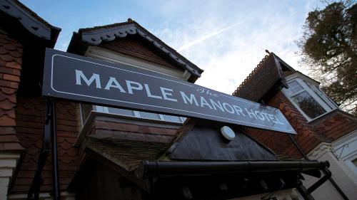 a street sign for mayle manor on a building at The Maple Manor Hotel and guest holiday parking in Crawley
