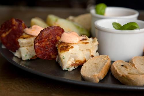 a plate of food on a wooden table with food at The Maple Manor Hotel in Crawley