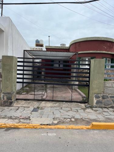 a fence in front of a building at Alojamiento en La Falda - MSL in La Falda