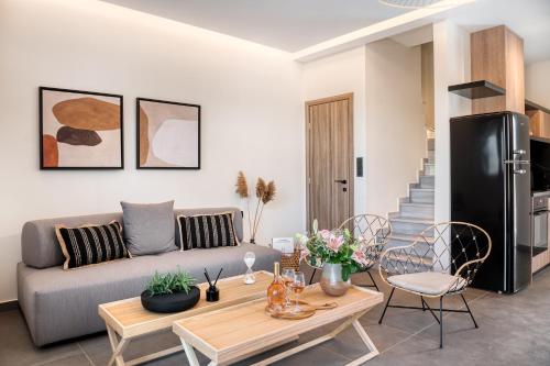 a living room with a couch and a table at Sezian Boutique Homes and Villas in Preveza