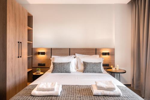 a bedroom with a large bed with two towels on it at Sezian Boutique Homes and Villas in Preveza