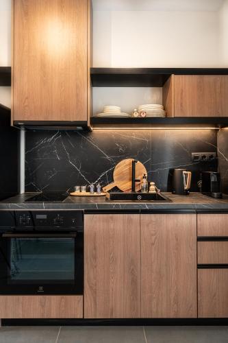 a kitchen with a sink and a stove and cabinets at Sezian Boutique Homes and Villas in Preveza