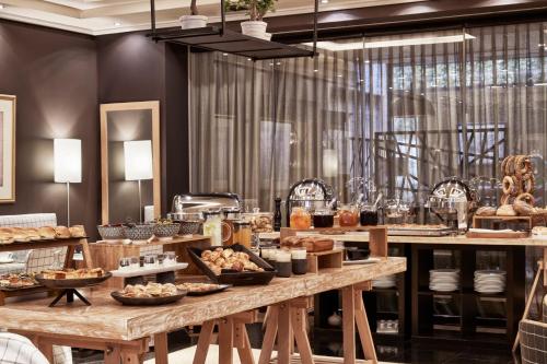 a bakery with a table filled with bread and pastries at Sea View Cityscape Hotel in Athens
