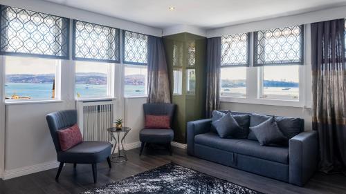 a living room with a couch and chairs and windows at Loop Hotel Bosphorus İstanbul in Istanbul