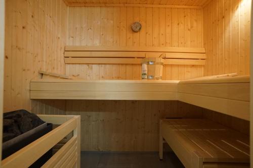 a sauna with wooden walls and wooden shelves at Witte Bank in Büsum