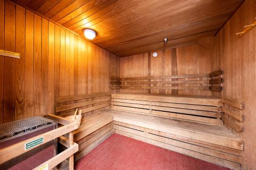 an empty sauna with wooden walls and benches at Olympic Village Inn Olympic Valley in Olympic Valley