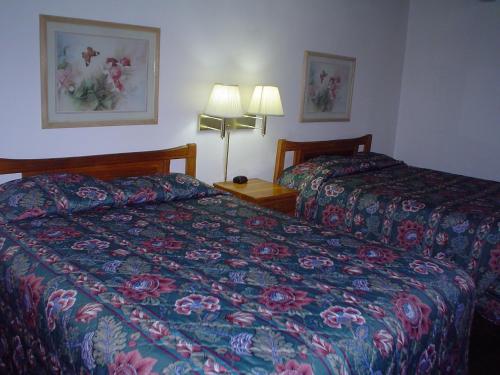 a hotel room with two beds and two lamps at Avenue Motel Wenatchee in Wenatchee