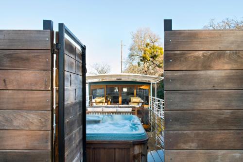 a hot tub on a deck between two wooden doors at Escale Sur Seine in Paris