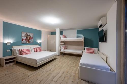 a bedroom with two beds and a bunk bed at Bellagio Village - Holiday Apartments by the Lake - Seasonal Warm Pool and Sauna in Oliveto Lario