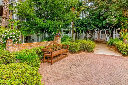 a bench sitting on a brick path in a garden at Baytowne Wharf - Pilot House #323 in Destin