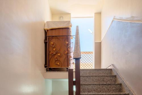 a set of stairs with a clock on the wall at A casa tua Affitti brevi in Noto