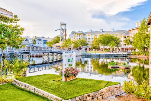 a sign in front of a river with buildings at Baytowne Wharf - Pilot House #323 in Destin