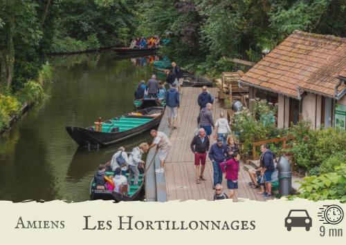 a group of people standing on a dock with boats at Le Chat d'Or - 35m2 - Terrasse - BBQ - WIFI HD in Amiens