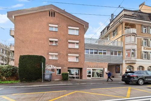 a person walking down a street in front of a building at Beautiful Boutique Apartment DRAHTZUG8 in Zürich