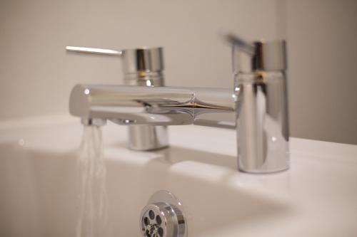 a sink with water coming out of a faucet at Printworks in Peterhead