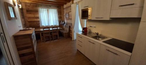 a kitchen with a sink and a counter top at Villaggio delle Alpi in Pré-Saint-Didier