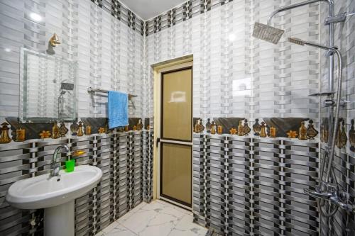 a bathroom with a sink and a shower at Noby Guest House in Luxor
