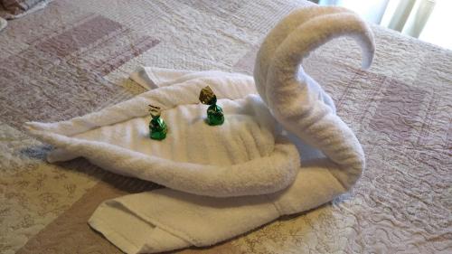 two towel animals are sitting on a bed at Casa pedrolo in Outes