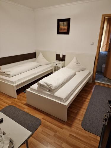 a room with two beds and a couch at Pensiunea Terra in Păcăleşti