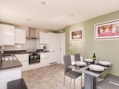 a kitchen and dining room with a table and chairs at Derwent House in Pickering