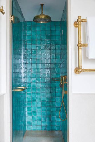 a bathroom with a shower with blue tiles at Villa Sant'Andrea, A Belmond Hotel, Taormina Mare in Taormina