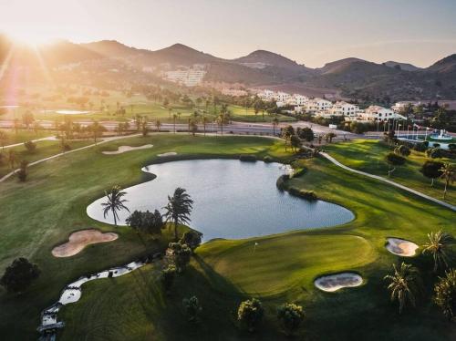 an aerial view of a golf course with a pond at Cozy House in La Manga Club in Atamaría