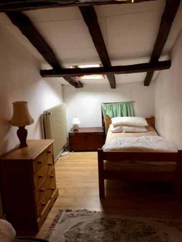 - une chambre avec un lit et une commode dans l'établissement Beautiful cottage with private pool in France, à Chatain