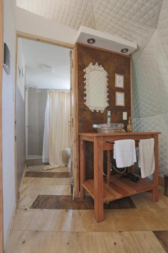 a bathroom with a wooden vanity and a sink at Ecoglamping Tafí del Valle in Tafí del Valle