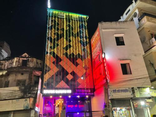 a tall building with a lit up facade at night at Hotel Benaras Gharana Inn in Varanasi