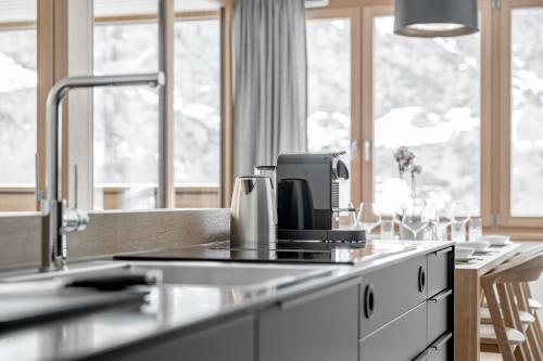 a kitchen counter with a coffee maker on it at all inclusive Hotel Lohmann in Obergurgl