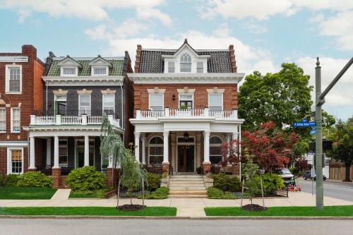a large red brick house with a white turret at The Boulevard Inn in Richmond