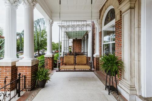 a front porch of a house with columns and chairs at The Boulevard Inn in Richmond