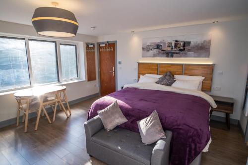 a bedroom with a large bed and a table and chairs at Magnolia House, Rye in Rye