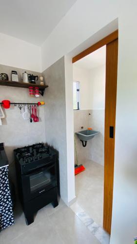 a kitchen with a black stove in a room at Vila Dos Diamantes - Lencois Bahia in Lençóis