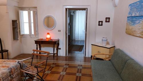 a living room with a couch and a table at Antica Via delle Aie in Ruffano
