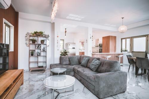 a living room with a couch and a table at SunnyVillas: 4BR Villa☆Private Pool + Jacuzzi - Villa Amelie in Protaras