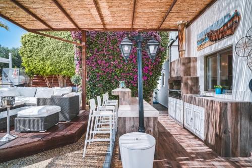 a pergola with a table and chairs on a patio at SunnyVillas: 4BR Villa☆Private Pool + Jacuzzi - Villa Amelie in Protaras