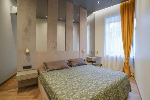 a bedroom with a large bed and a window at Forentinn Gedimino pr. in Vilnius