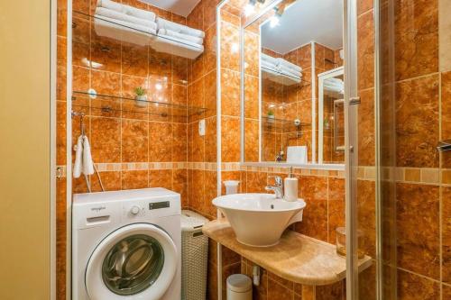 a bathroom with a washing machine and a sink at Spacious 2BD, fully equipped for a relaxing holiday in Split