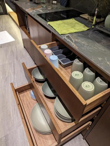 a drawer with plates and vases sitting on plates at Cottonwood Exclusive Villa Sagarmatha @Puncak in Bogor