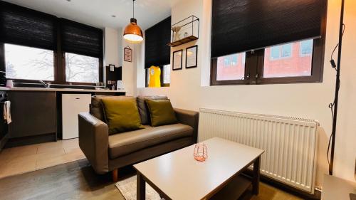 a living room with a couch and a table at Naps Inn in Birmingham