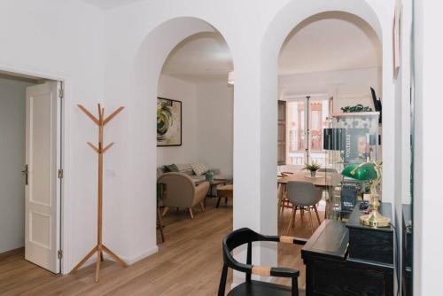 a living room with an archway and a dining room at Stylish apartment in the centre of Madrid-Malasaña in Madrid