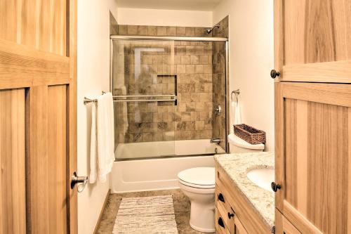 a bathroom with a toilet and a shower and a sink at Waterfront Apt with Mtn View, Walk Into Town! in Craig