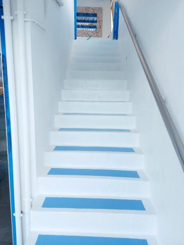 a set of stairs with blue and white paint at Mpitzarakis Studio On the Beach in Agia Pelagia