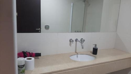 a bathroom counter with a sink and a mirror at BERSAGLIERE in Rosario