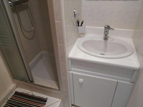 une salle de bain avec un lavabo et une douche dans l'établissement Appartement T3 Climatisé - Terrasse Sud, Parking Privé, 6 Couchages - Le Grau-du-Roi - FR-1-250-218, au Grau-du-Roi