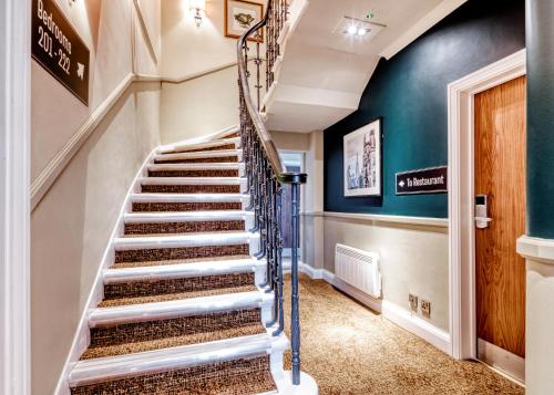a spiral staircase in a home with green walls at Toby Carvery Edinburgh West by Innkeeper's Collection in Edinburgh