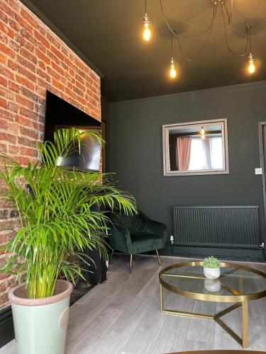 a living room with a couch and a glass table at Salt Life One Bedroom Apartment in Brighton & Hove